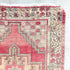 This handwoven vintage Turkish rug has beautiful neutral and light gold accents. Background color is a deep salmon pink / red. Niğde. 