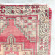 This handwoven vintage Turkish rug has beautiful neutral and light gold accents. Background color is a deep salmon pink / red. Niğde. 